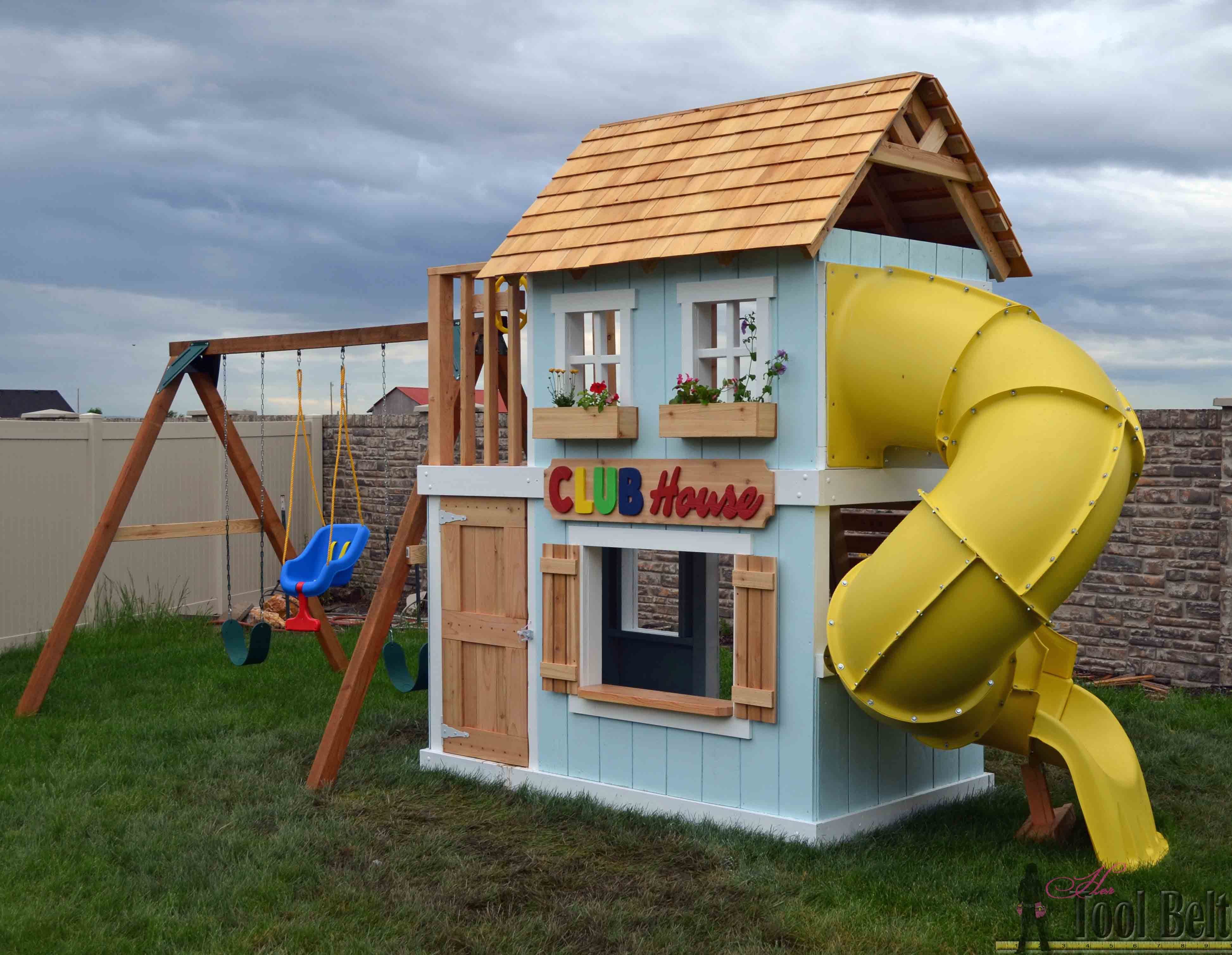 wooden playhouse with swing